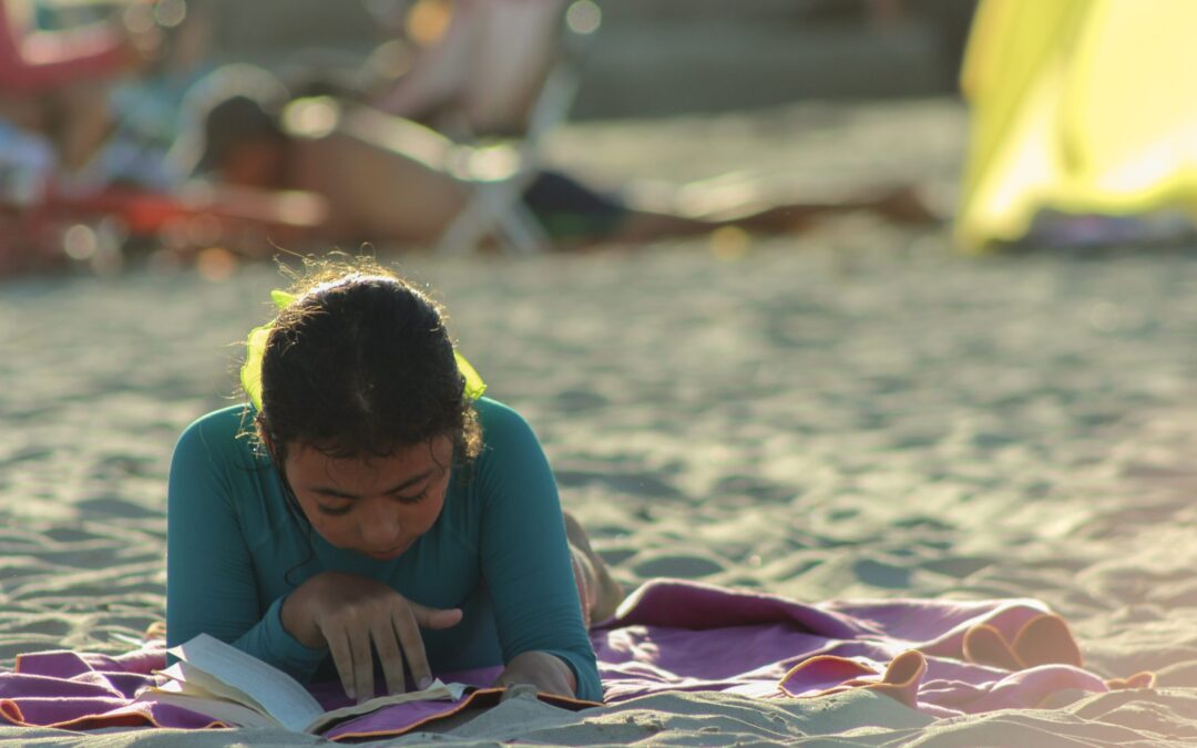 Girl reading on the beach.