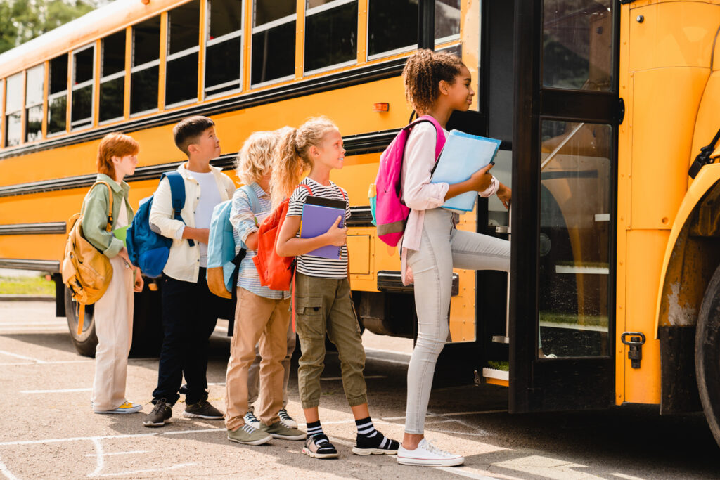 Children board school bus.